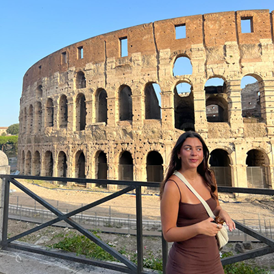 Woman Posing For Photo Outside Colosseum