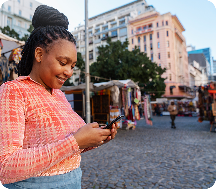 Woman Using Phone at Outdoor Market