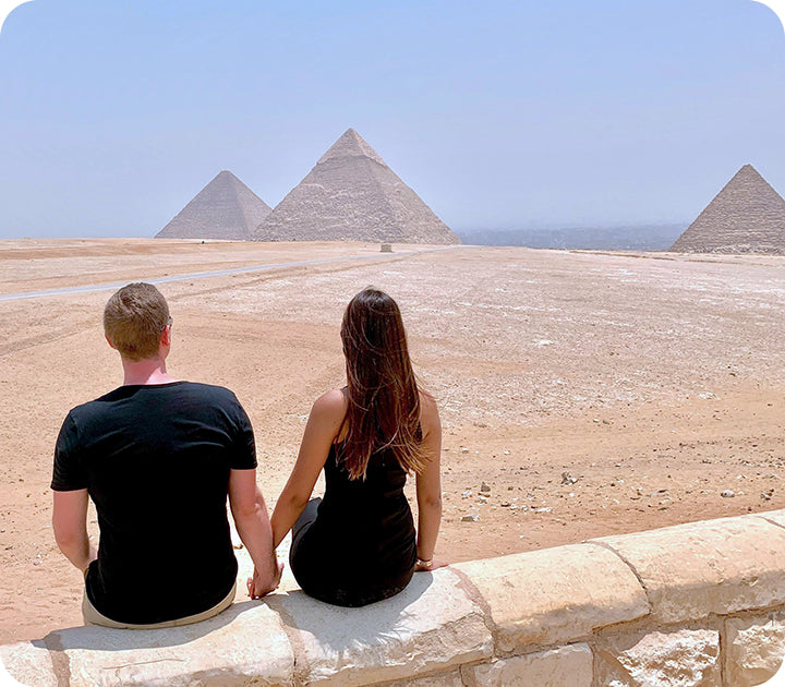 Young Couple Looking Out Across Giza Pyramids